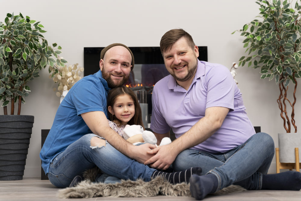 Two dads holding their baby