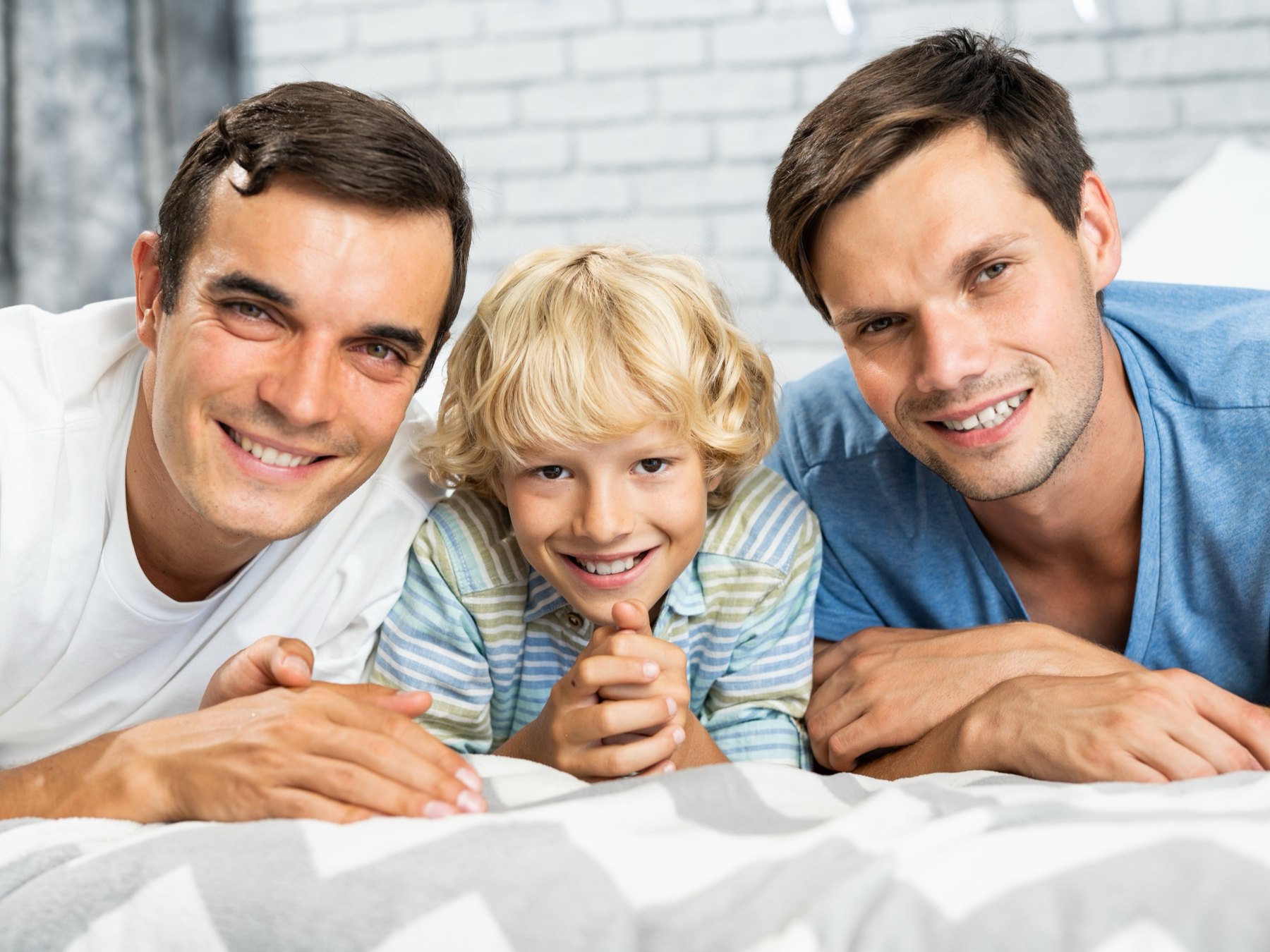 Two fathers at home with their son